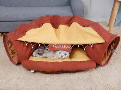 Rust red collapsible cat tunnel play bed with hanging toy panel and padded center