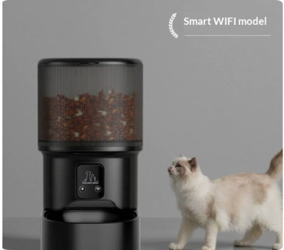 Black WiFi smart pet feeder with cat beside base and textured hopper