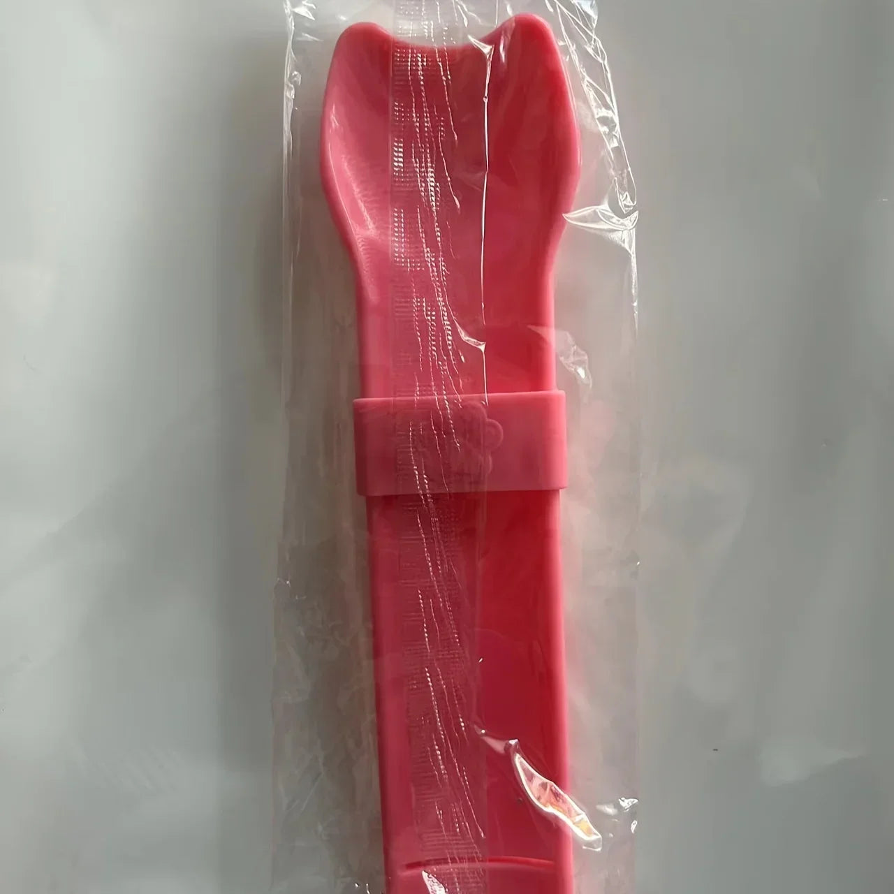 Pink cat lick treat spoon in clear plastic bag