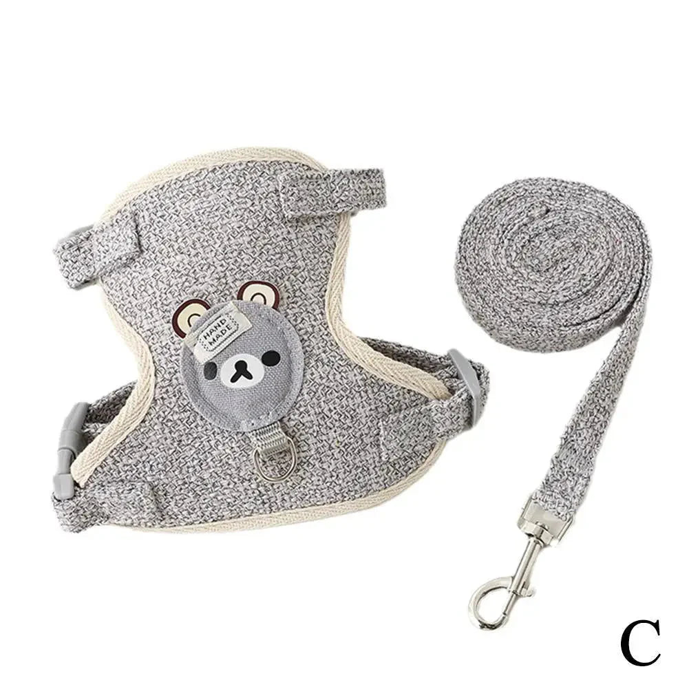 Gray speckled pet harness vest with bear patch and adjustable leash, coiled rope