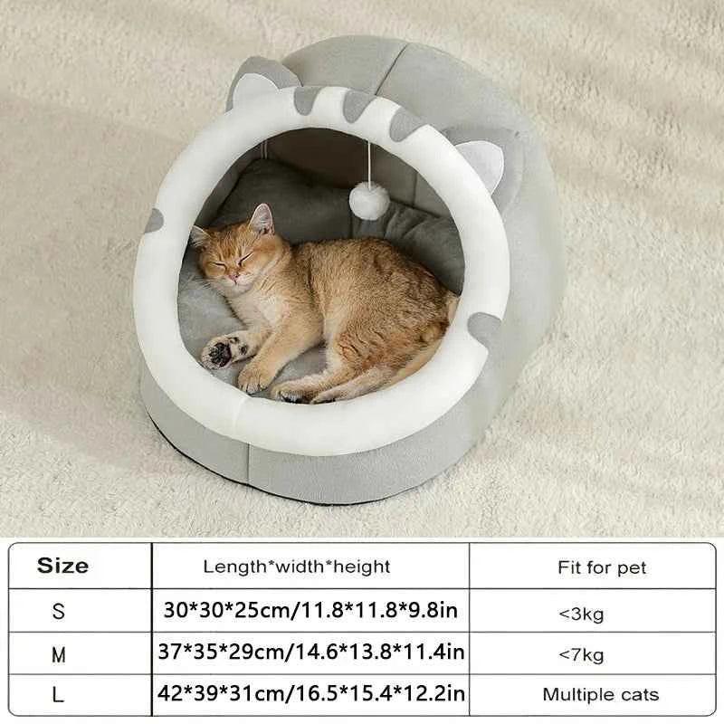 Ginger cat sleeping in a grey WTN Essentials Cozy Cave Cat Bed with a size chart below.