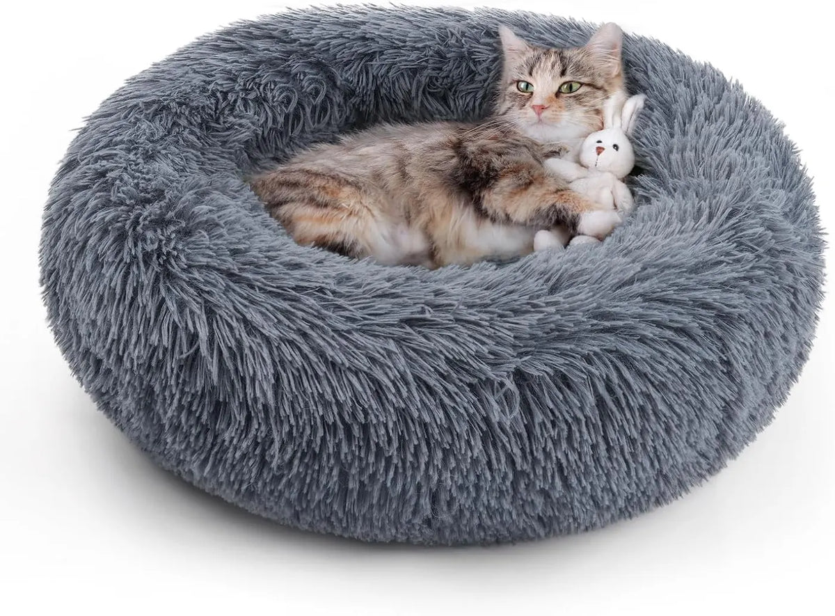 Round gray plush cat bed with a cat resting and a small toy