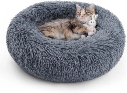 Round gray plush cat bed with a cat resting and a small toy