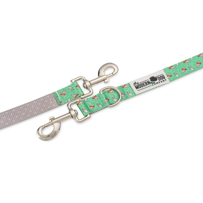 Green pizza-pattern dog leash close-up with two silver spring clips and label
