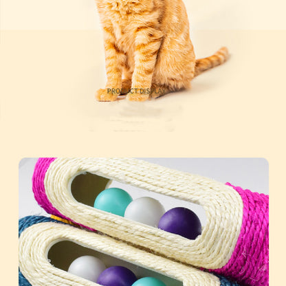 Orange tabby cat beside a pink and blue sisal drum toy with colored rolling balls