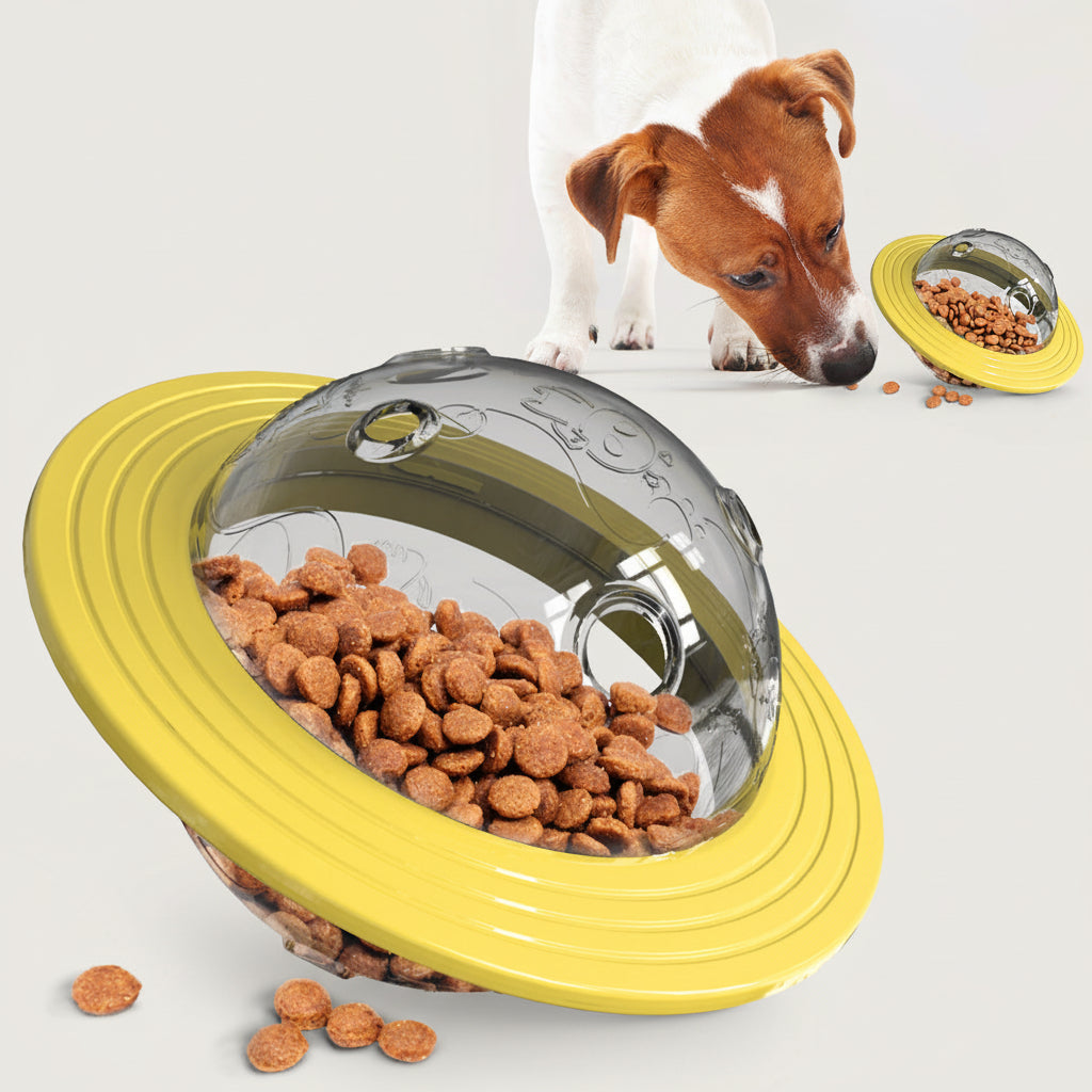 Yellow interactive dog treat toy with clear dome holding kibble and ridged rim