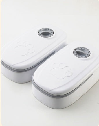 Pet feeder with two gray dial openings on a white double-unit housing