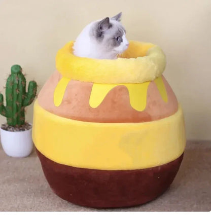 Cat in honey pot-shaped plush bed, cozy pet bedding for cats, soft and warm cat nest