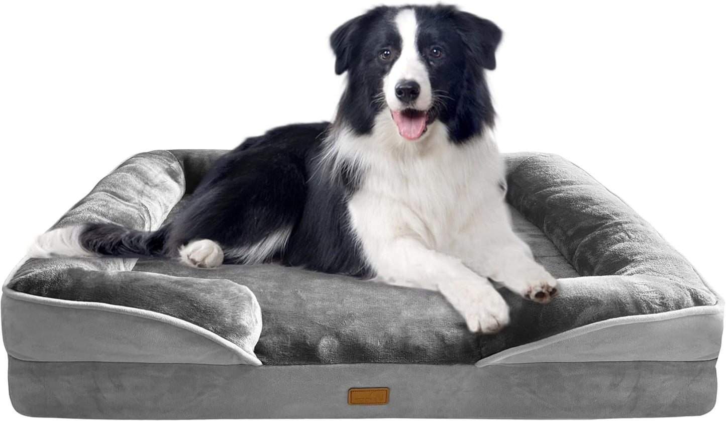 Black-and-white dog relaxing on a gray dog bed with padded bolster pillows