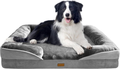 Black-and-white dog relaxing on a gray dog bed with padded bolster pillows
