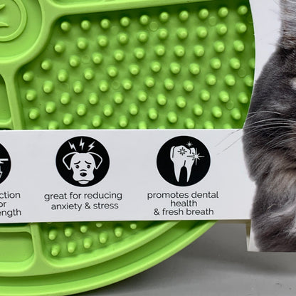 Green slow feeder licking mat with raised bump texture and paw-friendly design