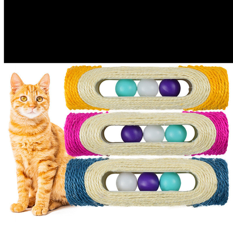 Orange cat next to three sisal drum toys with purple, teal, and white rolling balls