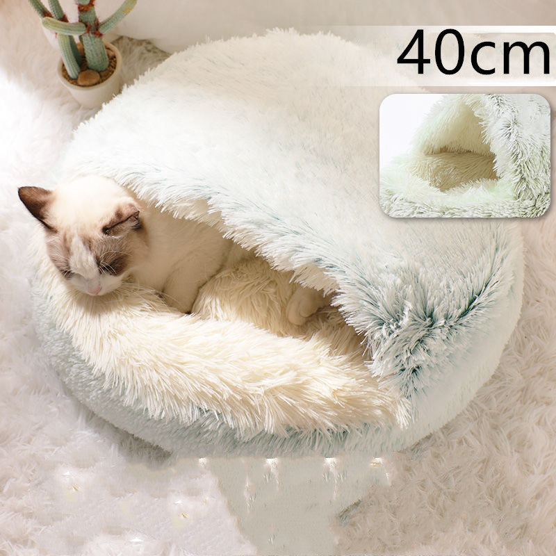 Light blue and cream plush oval pet bed with feathered shag rim and cat inside