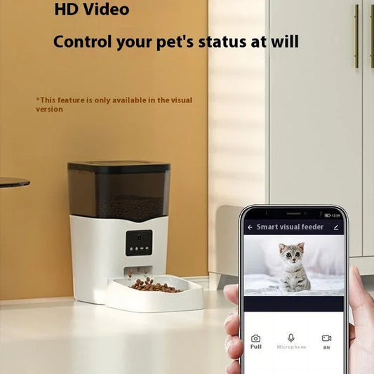 White automatic cat feeder with dark front control panel, shown with phone app screen