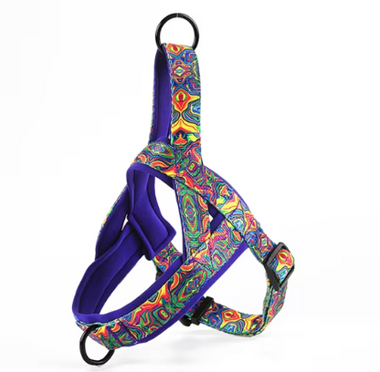 Dog harness in blue and purple multicolor pattern with black straps and metal ring
