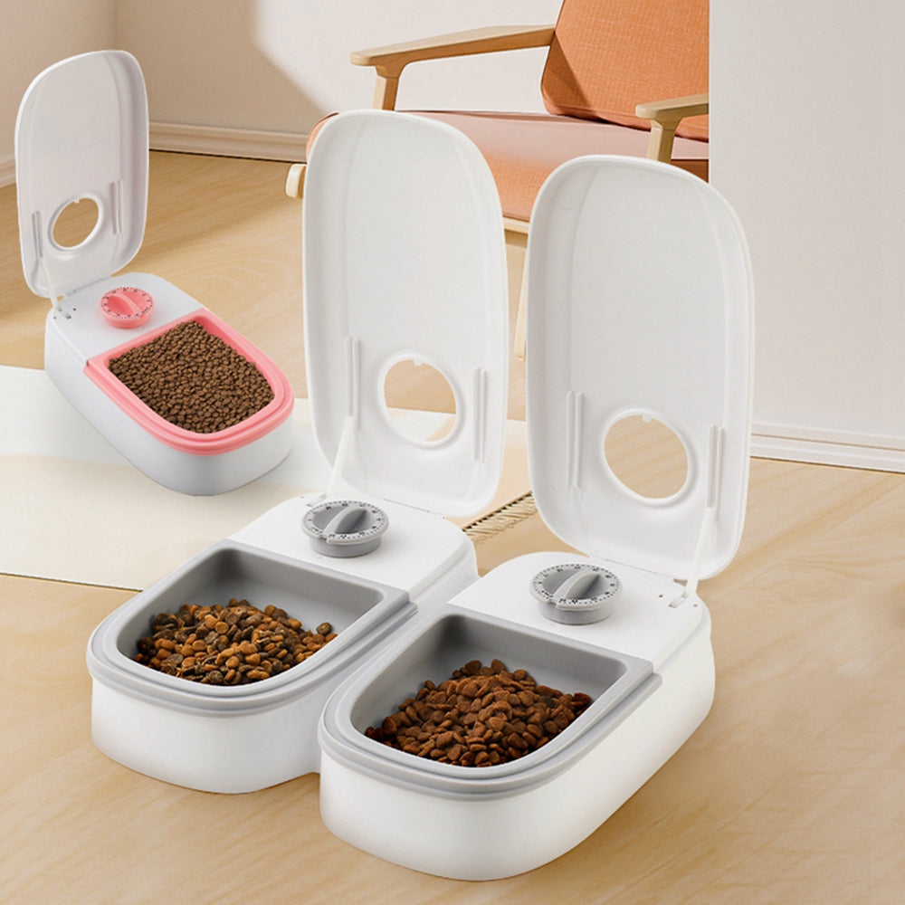 Pet feeder with open lid and two white compartments, showing two bowl portions