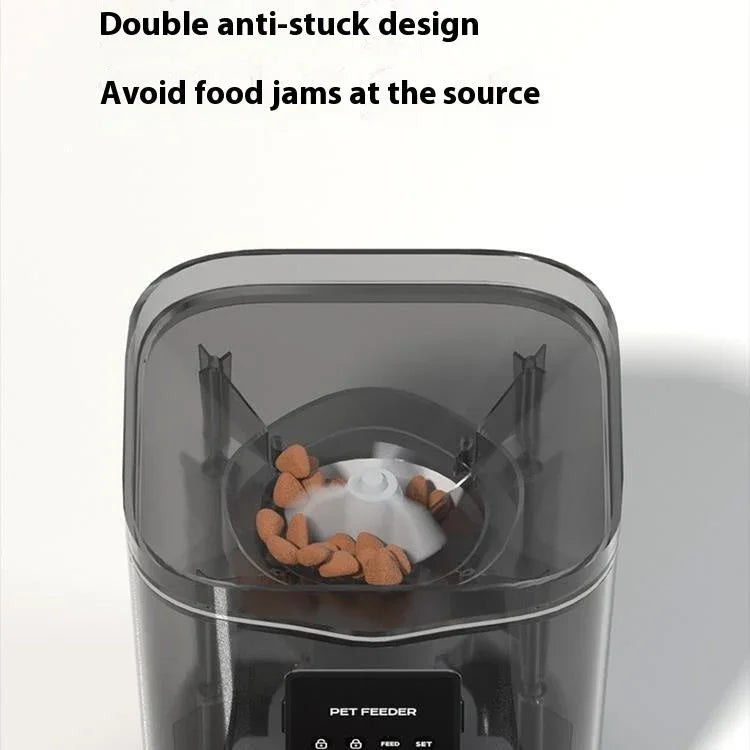 Transparent-lid automatic cat feeder with dark interior, visible anti-stuck feed bowl