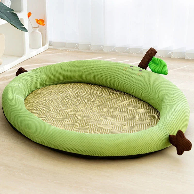 Green apple-shaped pet cooling mat with woven center, perfect for cats and dogs to relax on.