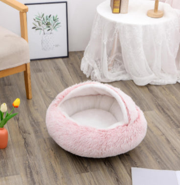 Cozy winter plush pet bed, small pink round cave with white plush inner lining.