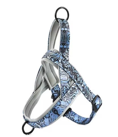 Dog harness in blue and white patterned fabric with black straps and metal ring