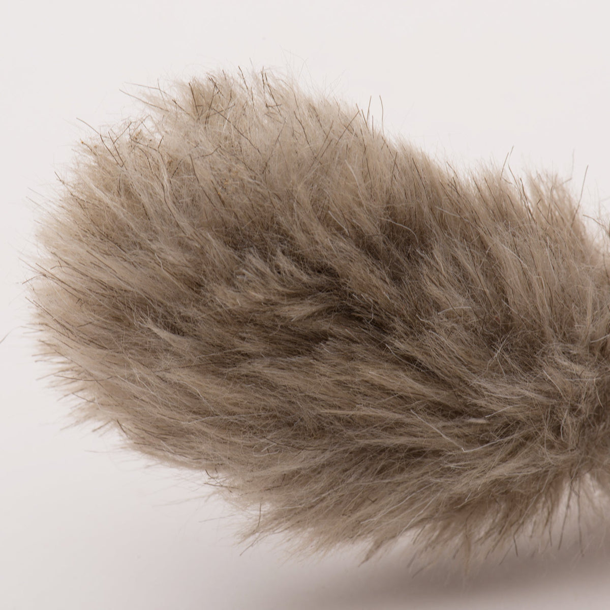 Brown plush squirrel tail section with shaggy fur