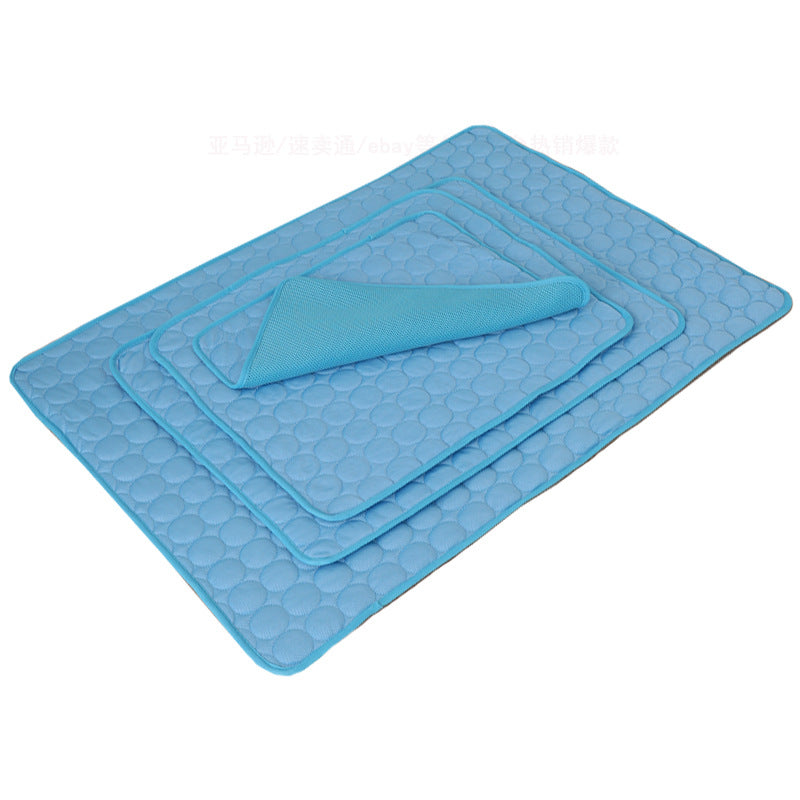 Blue cooling pet mat with matching folded cover and textured honeycomb surface