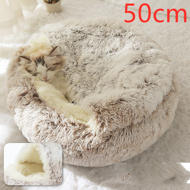 Beige plush oval pet bed with cat curled inside, thick shag fabric