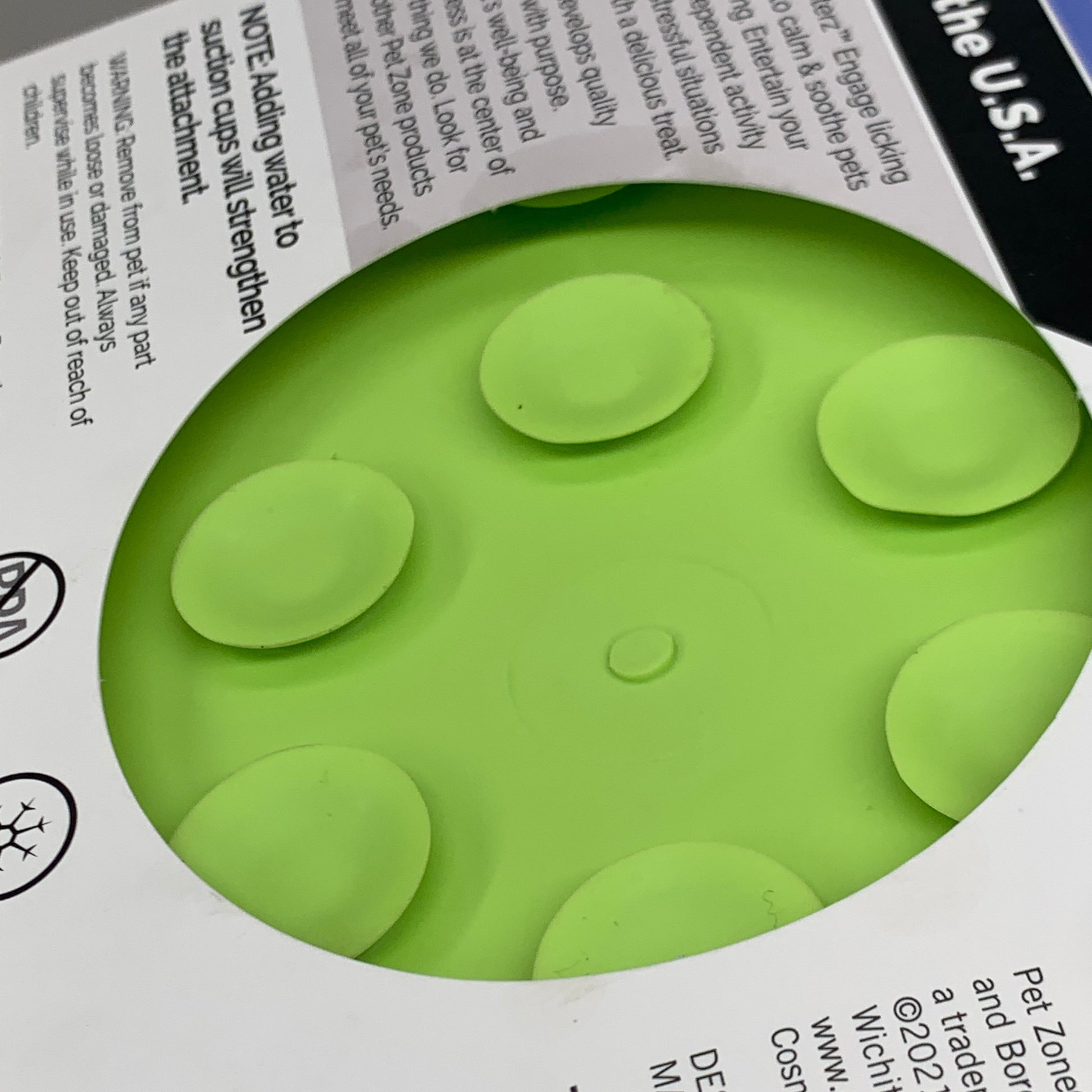 Green slow feeder lick mat with raised lick bumps and suction points