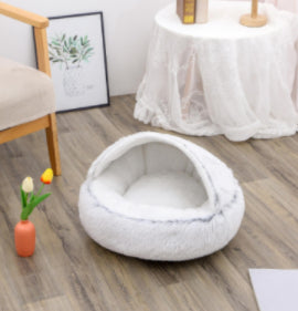 White plush pet bed with compact oval U-shaped opening and soft interior
