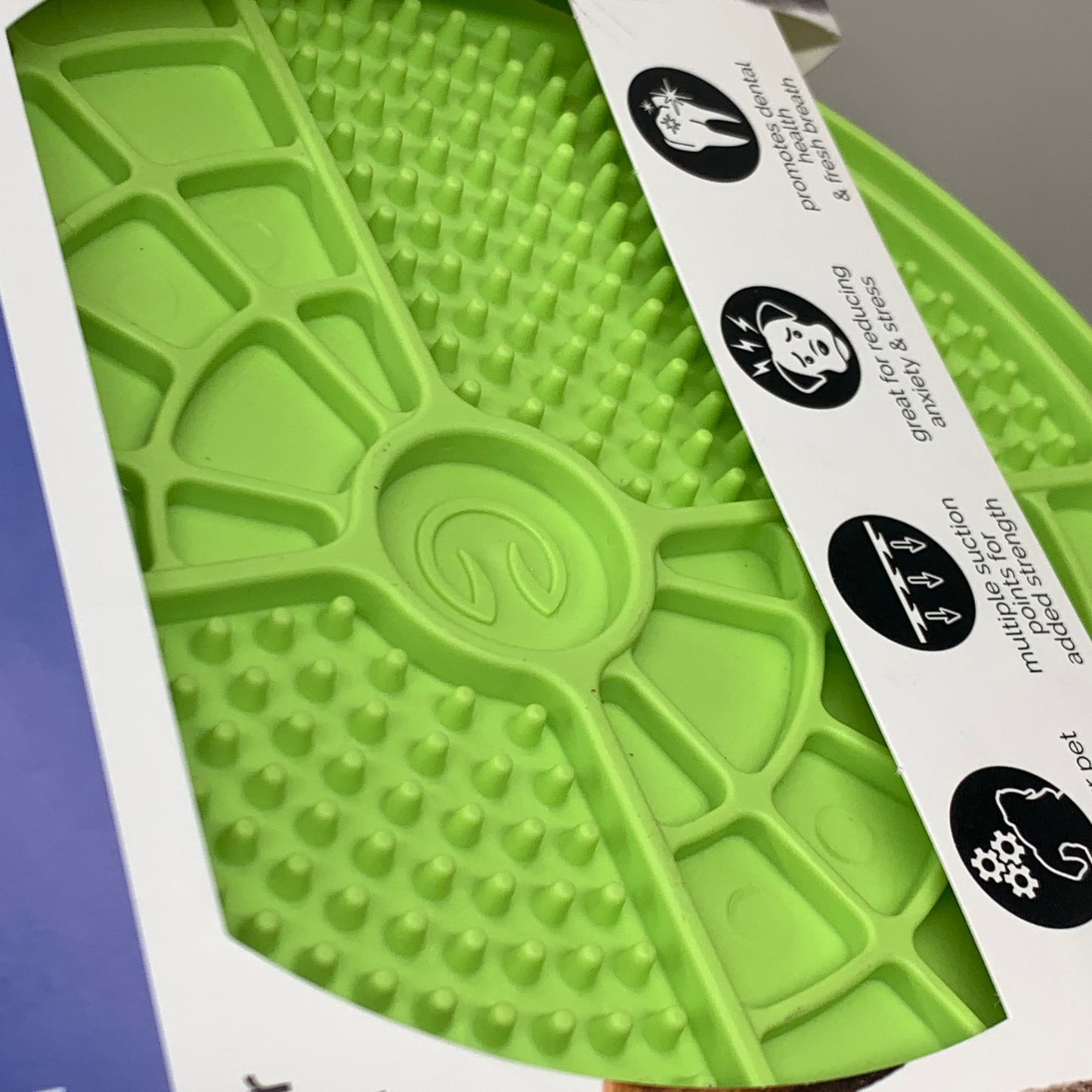 Green lick mat surface with raised channels and suction cup pattern detail