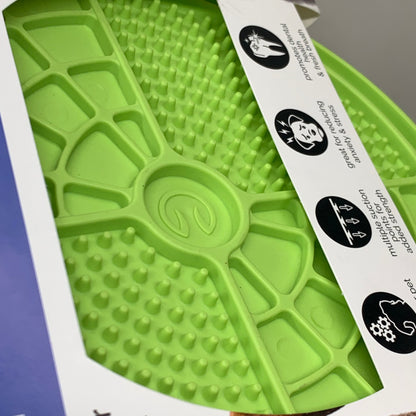 Green lick mat surface with raised channels and suction cup pattern detail