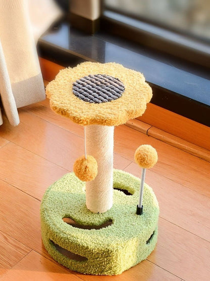 Single cat scratching post with dangling balls, yellow top and green circular base.
