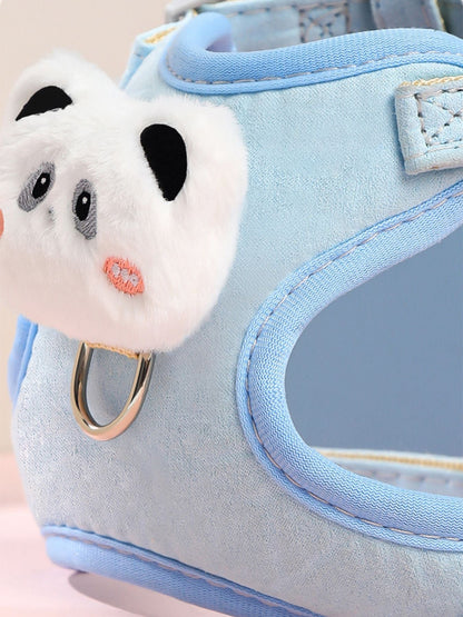 Close-up of white plush bear face patch on light blue pet harness with D-ring