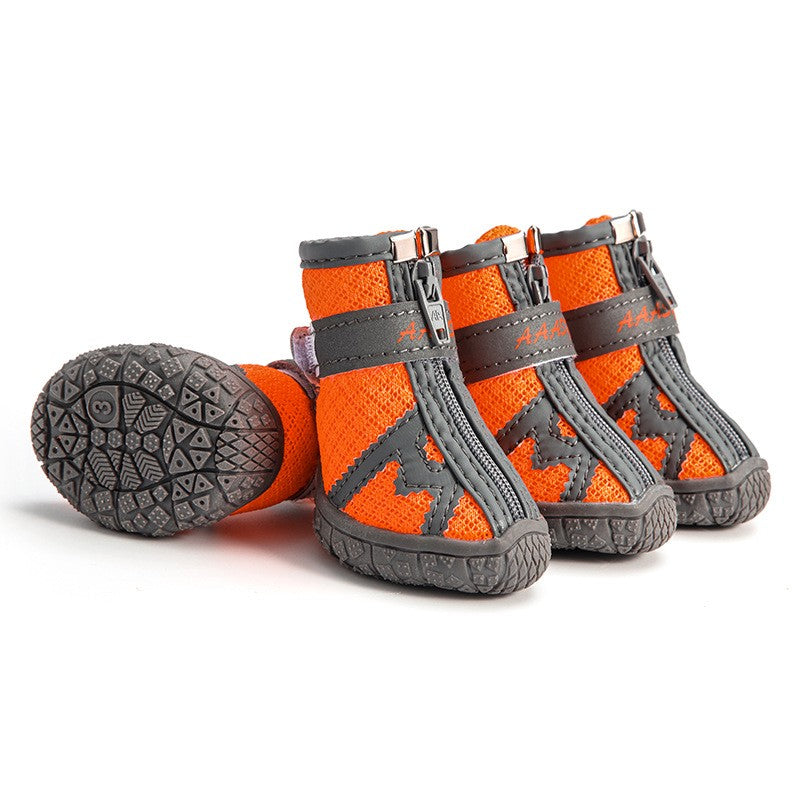 Waterproof pet rain boots, tangerine-orange with gray webbing and grippy rubber sole.