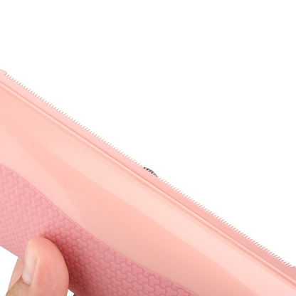 Close-up of pink pet grooming comb teeth along the edge