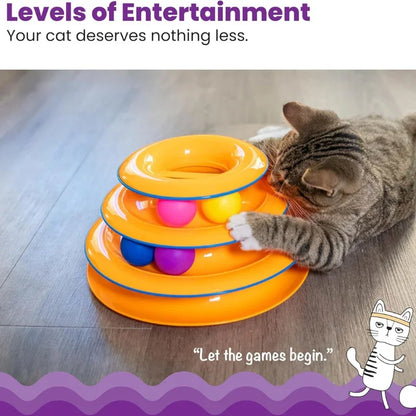 A tabby cat playing with a WTN Essentials 3-tier orange interactive spinning ball track toy.