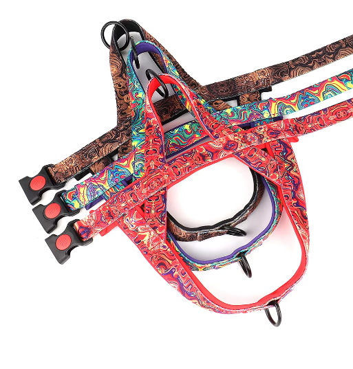 Dog harness without the leash, multicolor patterned with red edging and three black adjusters