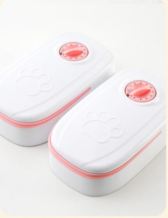 Pet feeder with two red dial controls on a white double-unit housing