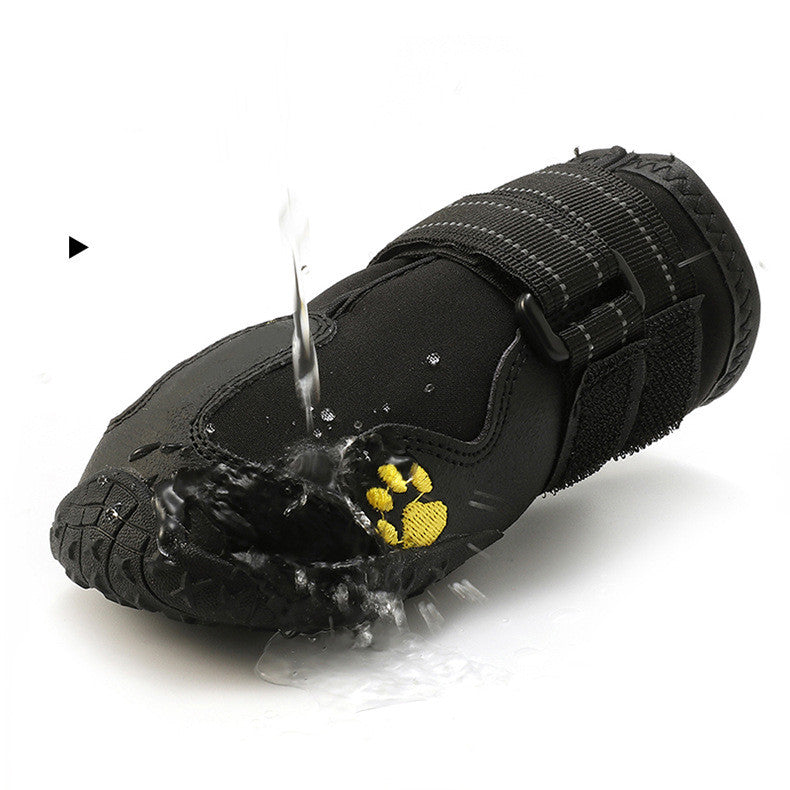Black waterproof dog boots with paw-print patch, hook-and-loop straps, water-splash detail