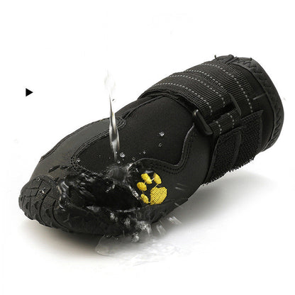 Black waterproof dog boots with paw-print patch, hook-and-loop straps, water-splash detail