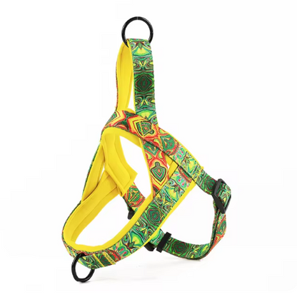 Dog harness with yellow body, green multicolor pattern, and black buckles and ring