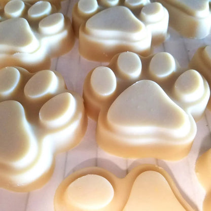 Assorted paw-shaped goat milk soap bars in tray