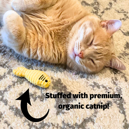 Brown plush squirrel cat toy near a sleeping orange cat on a rug