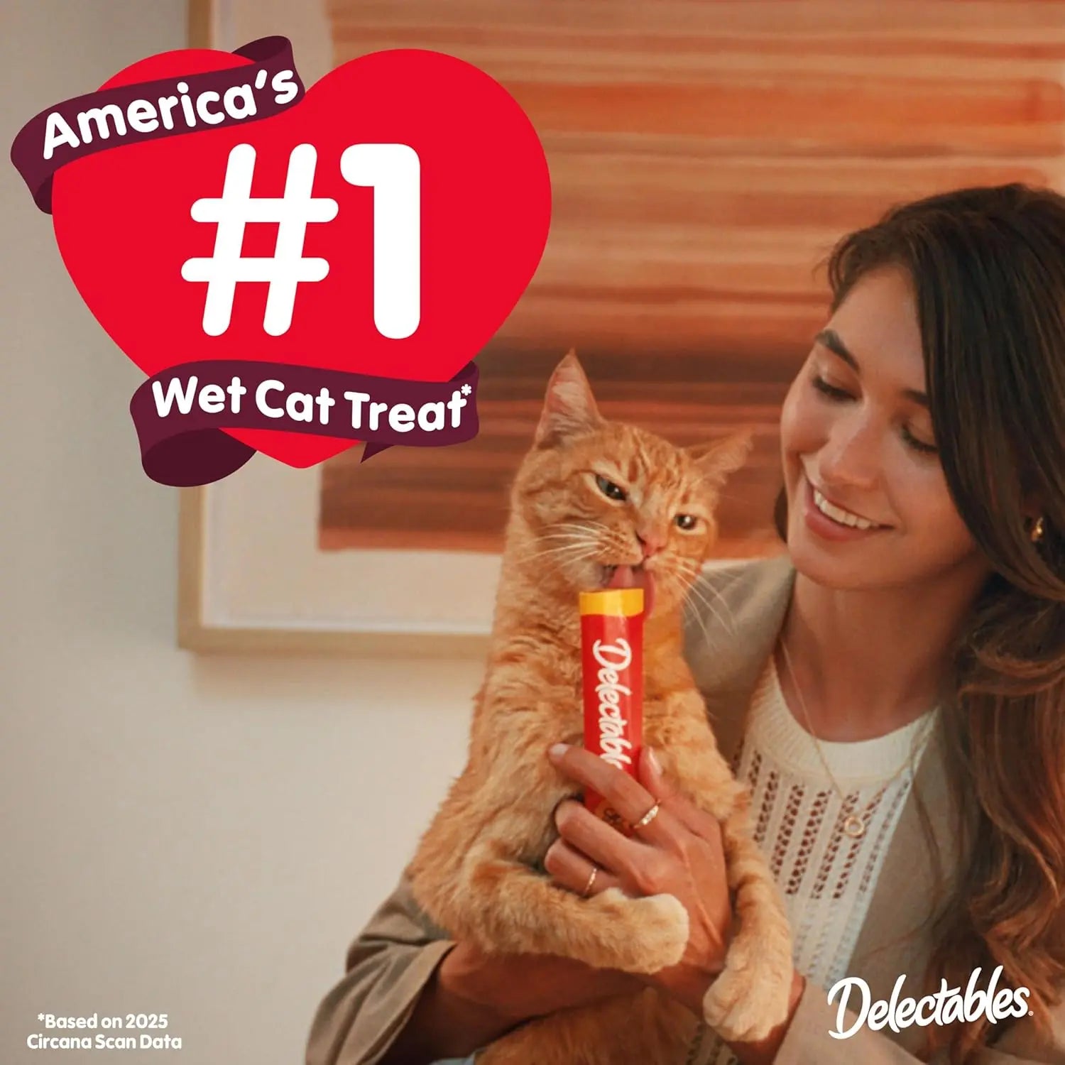 Lickable cat treat tube held by woman and cat, Delectables Squeeze Up