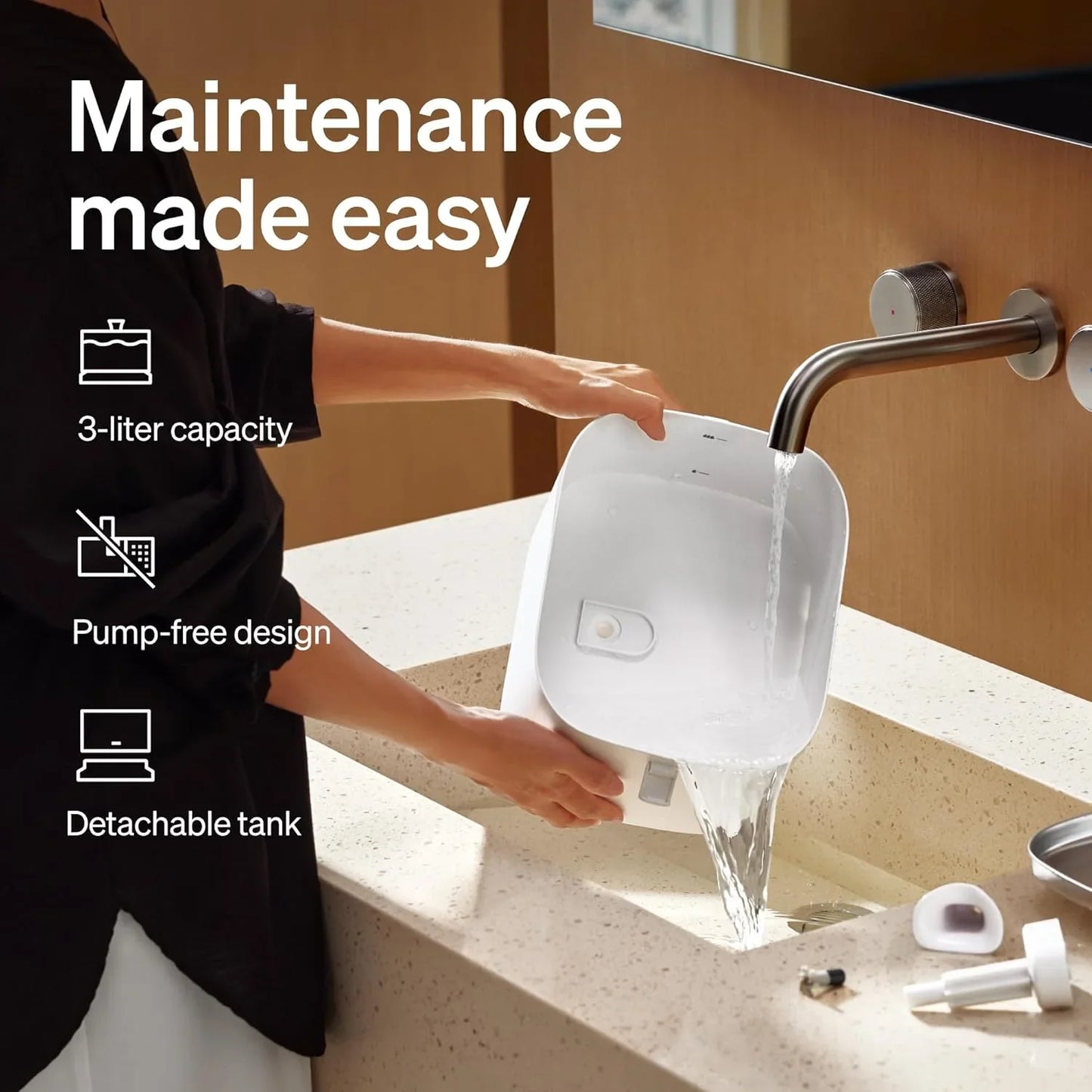 White automatic pet water fountain with detachable tank; hands holding while water pours.