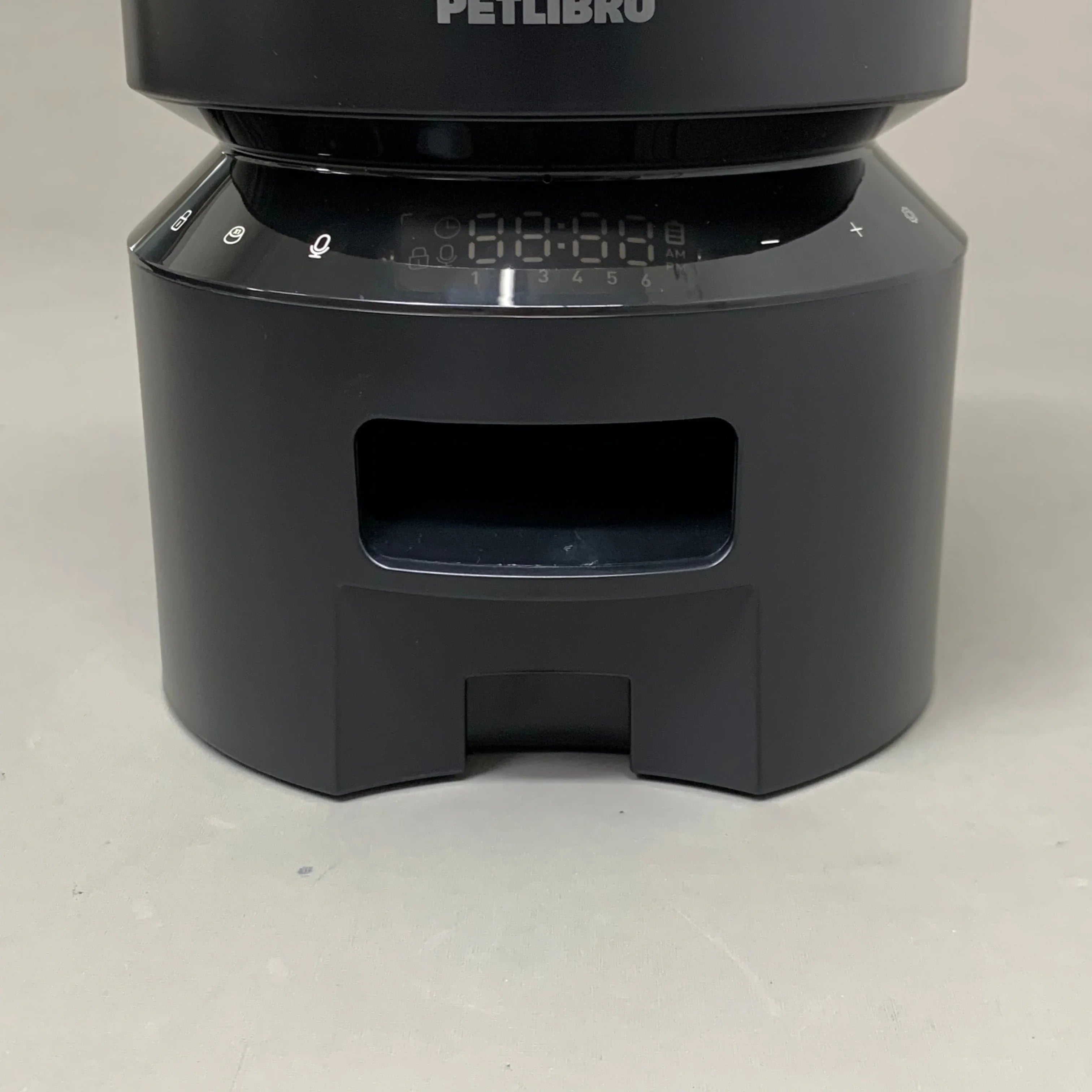 Black automatic pet feeder with digital display and touch controls for scheduled feeding