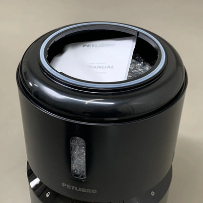 Black automatic cat feeder with top open, inner tray area visible