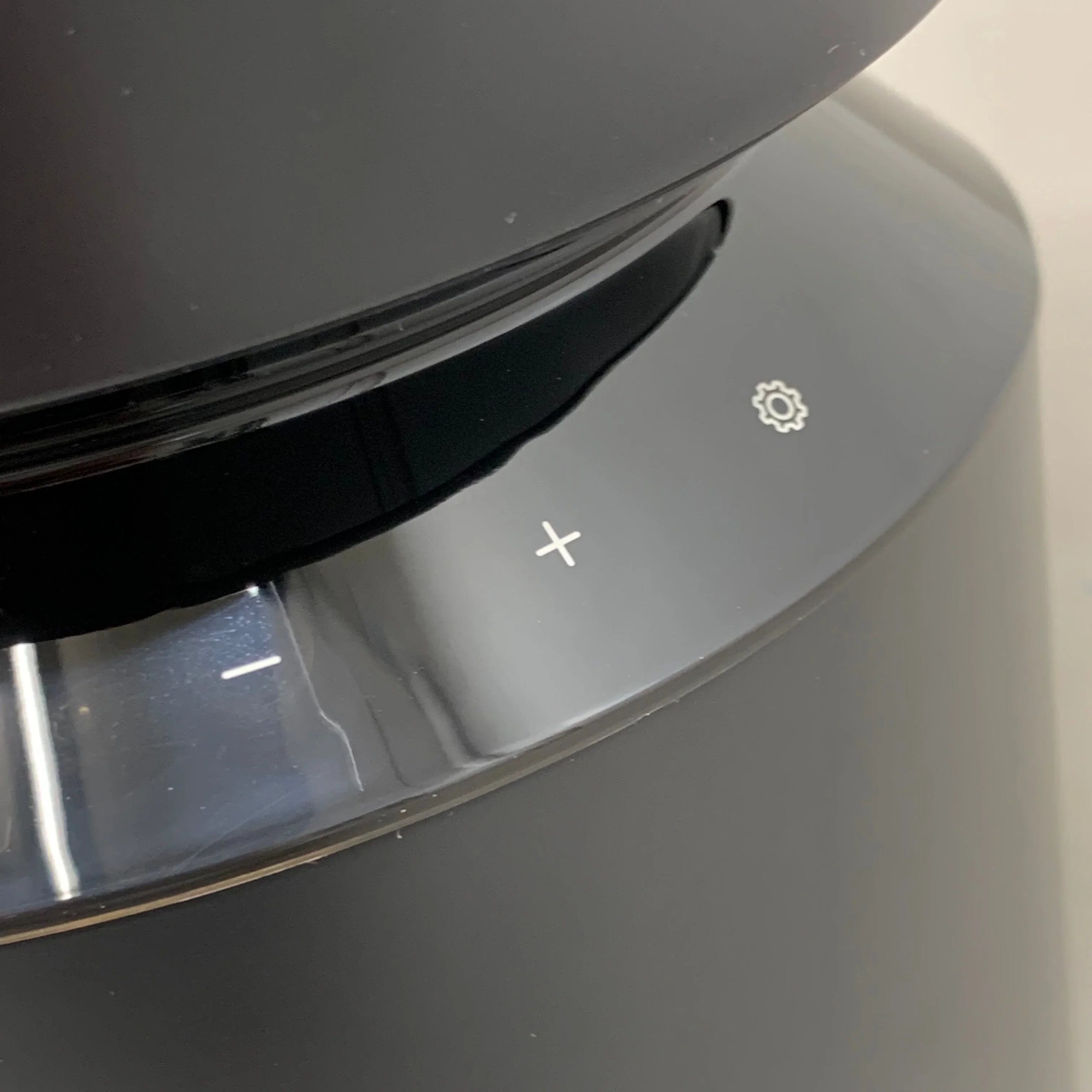Black pet water fountain control panel with plus, minus, and settings icons