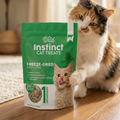 Green freeze-dried beef lung cat treat pouch on wooden floor with front branding
