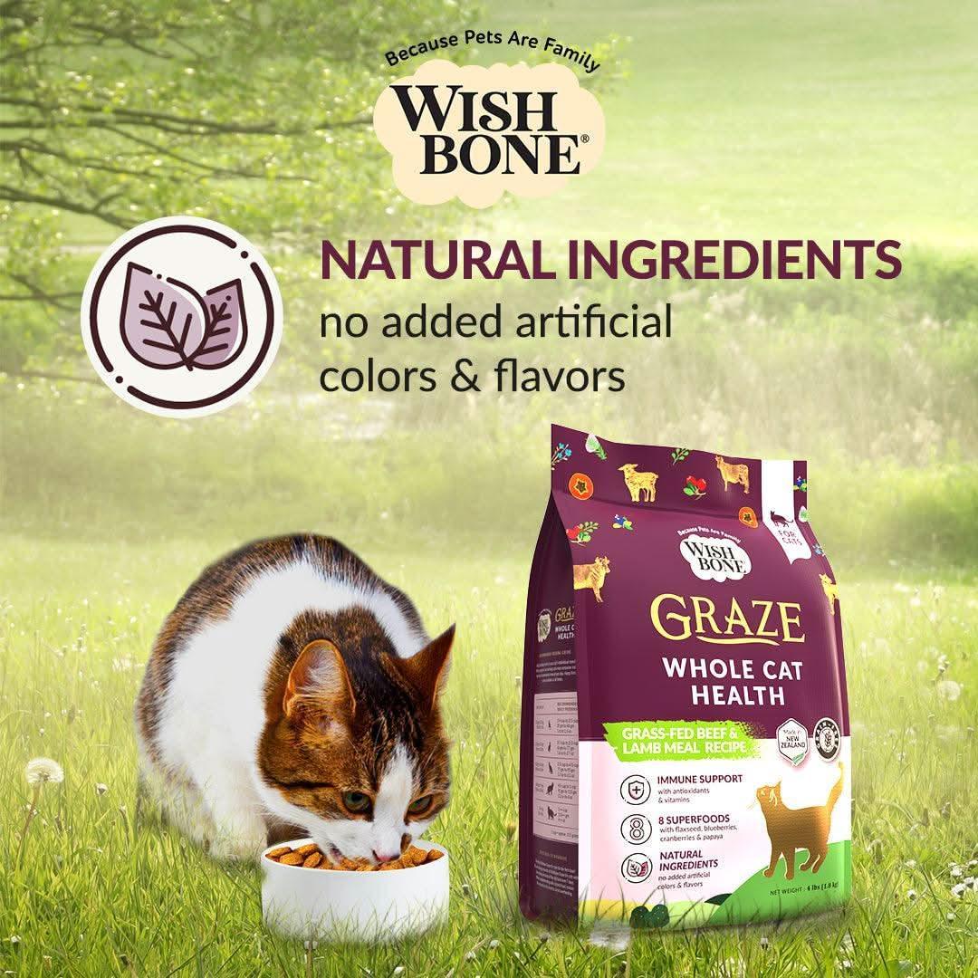 Wishbone Graze cat food bag with cat eating from bowl in natural ingredients scene